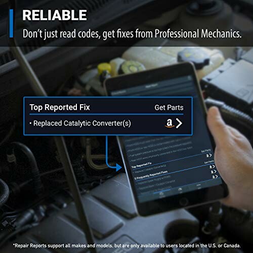 Mechanic using tablet for car diagnostics showing catalytic converter issue.