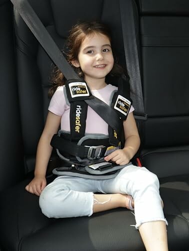 Child in car seat with safety harness