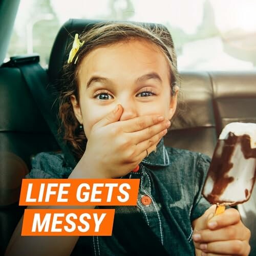 Child in car eating ice cream with a surprised expression.