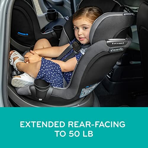 Child in a rear-facing car seat in a vehicle.