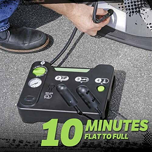 Portable tire inflator being used on car tire.